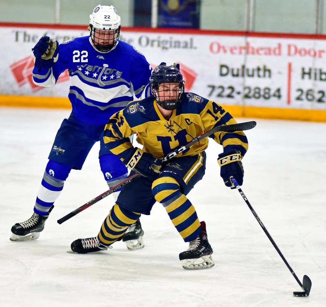 Hermantown hockey player battles for position in front of the net